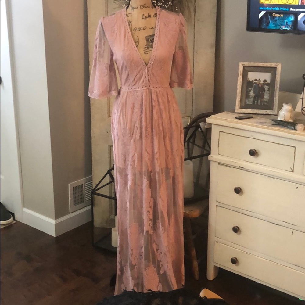 Pale pink romper with open lace back. Size L